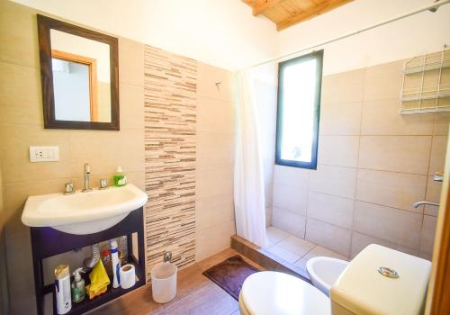 a bathroom with a sink and a toilet at Casa Barrio Acantilados proxima al mar in Mar del Plata