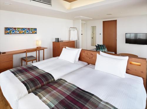 Un ou plusieurs lits dans un hébergement de l'établissement HOTEL STRATA NAHA