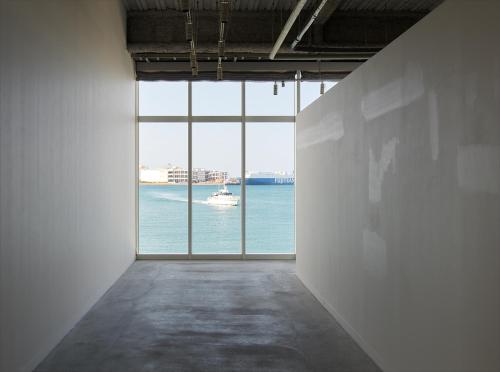 an empty room with a view of the water at HOTEL ANTEROOM NAHA in Naha