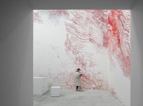 a person standing in front of a painting on a wall at HOTEL ANTEROOM NAHA in Naha