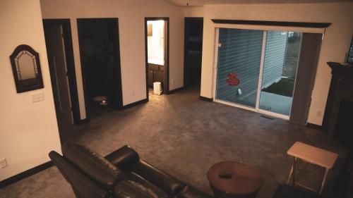 a living room with a couch and a large window at Brand new duplex in Cedar Rapids