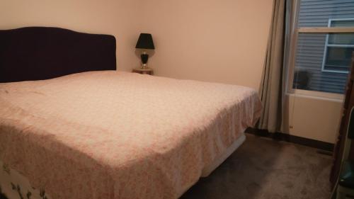 a bedroom with a bed and a window at Brand new duplex in Cedar Rapids