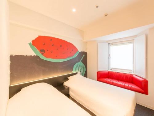 a room with two beds and a painting of a watermelon at Hotel Art Stay Naha Kokusai-Dori in Naha