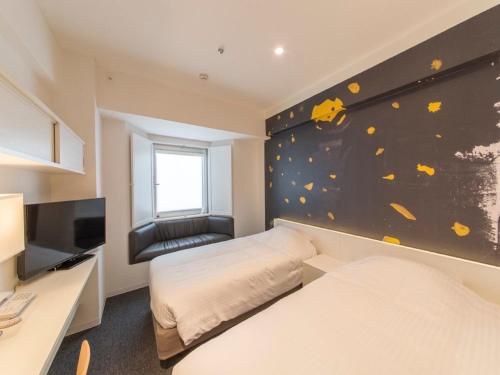 a bedroom with two beds and a wall with a mural at Hotel Art Stay Naha Kokusai-Dori in Naha