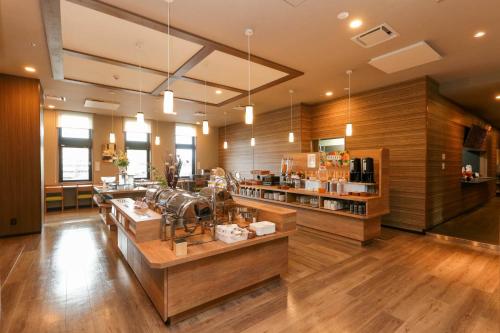 a large room with a store with wooden walls at Route Inn Grantia Tokai Spa&Relaxation in Tokai