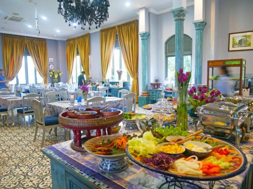 a buffet table with many plates of food on it at At Pingnakorn Huaykaew in Chiang Mai