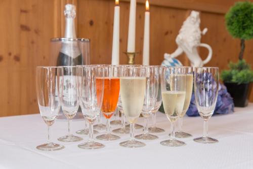 a row of wine glasses sitting on a table at Landhotel Grätz in Emmering