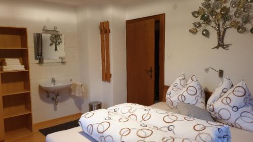 a bedroom with a sink and a bed with pillows at Landhaus Hoschek in Scheffau am Wilden Kaiser