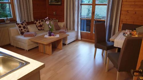 a living room with a couch and a table at Landhaus Hoschek in Scheffau am Wilden Kaiser