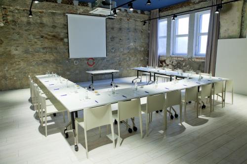 a large conference room with a long table and chairs at Catalonia Berlin Mitte in Berlin