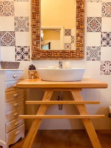 a bathroom with a sink and a mirror at Il Nuraghe del lago Coghinas in Oschiri