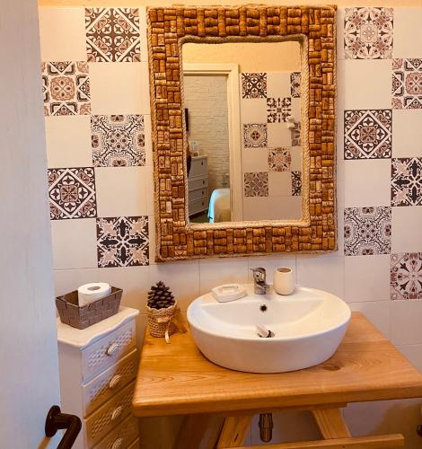 a bathroom with a sink and a mirror at Il Nuraghe del lago Coghinas in Oschiri