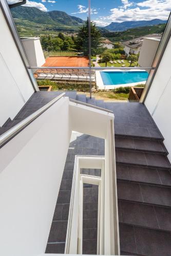 a view from the stairs of a house with a swimming pool at Appartement KroneLiving in Tirolo