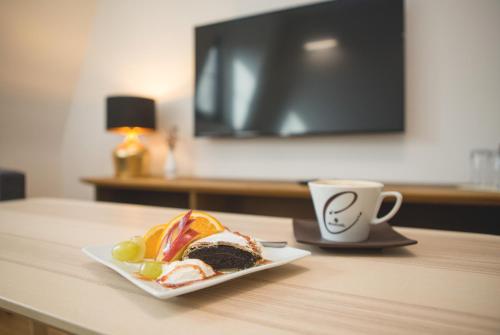 a plate of food on a table with a cup of coffee at Penzión ÁTRIUM in Prešov