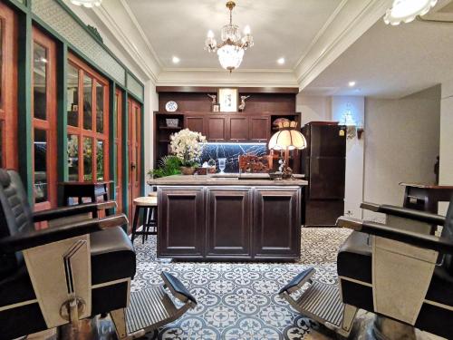 a living room with a kitchen and a kitchen island at The Knight House Bangkok in Bangkok