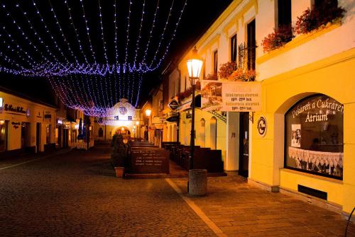 an empty street at night with purple lights at Penzión ÁTRIUM in Prešov