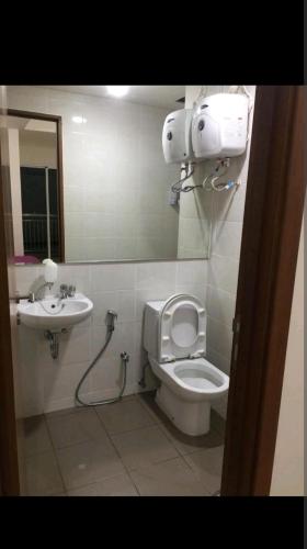 a bathroom with a toilet and a sink at 2 BR Jungle Decor Beautiful Sea View Fast Internet Top Of The Mall in Jakarta
