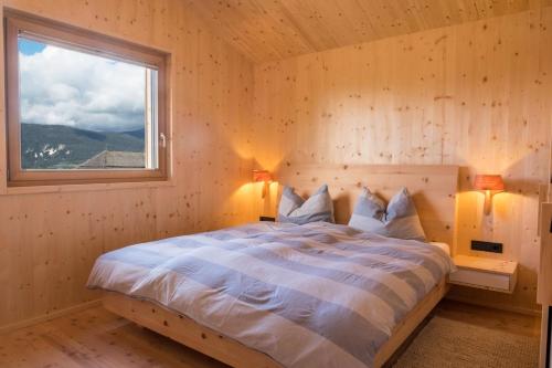 a bedroom with a bed in a room with a window at Landhaus Silene in Sarnonico