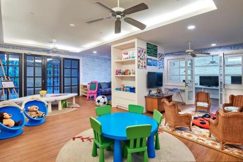 a childs play room with a table and chairs at The Danna Langkawi - A Member of Small Luxury Hotels of the World in Pantai Kok