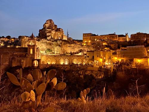 a view of a city at night at Il Sassetto in Matera