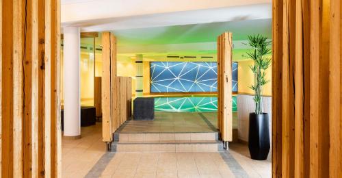a hallway with a room with a bed and a window at Seiblishof Superior Hotel Ischgl in Ischgl