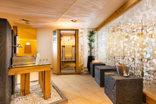 a living room with a stone wall at Seiblishof Superior Hotel Ischgl in Ischgl