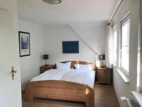 a bedroom with a bed with white sheets and pillows at Ferienwohnung Strandperle in Prerow