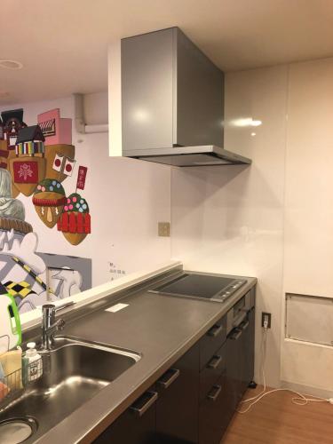 a kitchen with a sink and a counter top at Syukur Ofuna in Kamakura