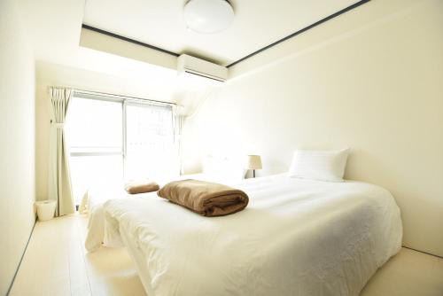 Llit o llits en una habitació de River Side Namba 801