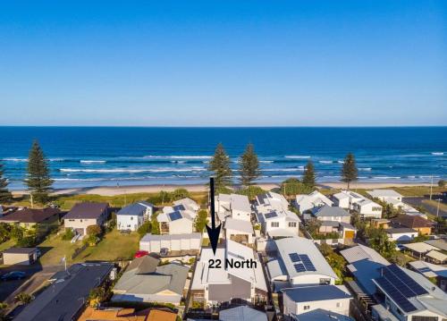 an aerial view of a beach with houses and the ocean at 22 North - Lennox Head in Lennox Head