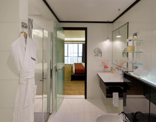 a bathroom with a white robe on a mannequin at Radisson Blu Hotel, Dubai Media City in Dubai