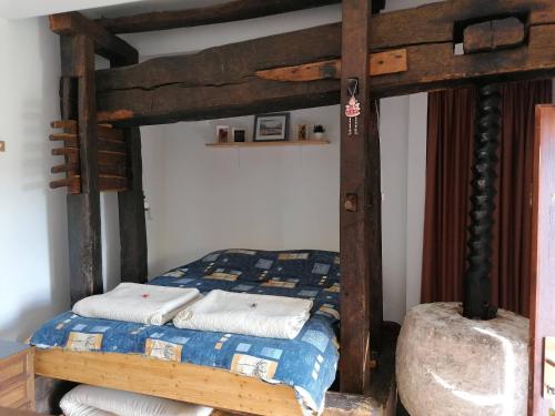 a bedroom with a wooden bed with towels on it at Rural house above the forest in Gornja Voća