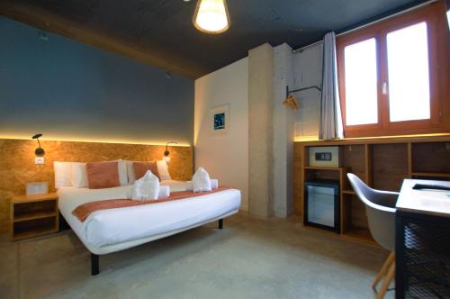 um quarto com uma cama branca e um lavatório em Brick Palma - Turismo de Interior em Palma de Maiorca