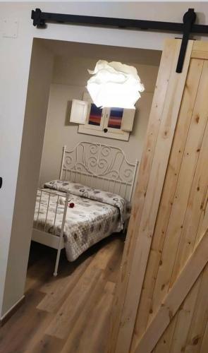 Habitación con cama y puerta de madera en B&B La Casetta en Castellaneta
