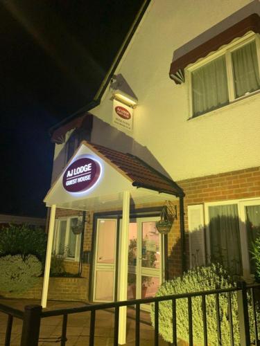 a restaurant with a sign on the front of a building at AJ Lodge in Slough