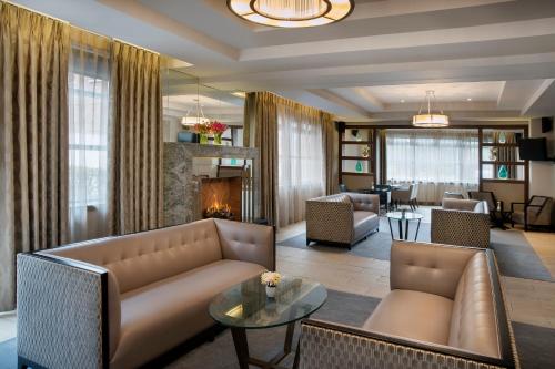 a living room with a couch and a fireplace at Crowne Plaza - Belfast by IHG in Belfast