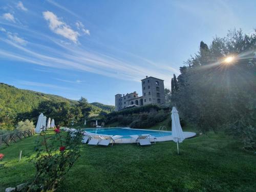 une piscine dans une cour avec un bâtiment en arrière-plan dans l'établissement Badia San Nicolò di Campolongo - Appartamento D'Onofrio, à Valfabbrica