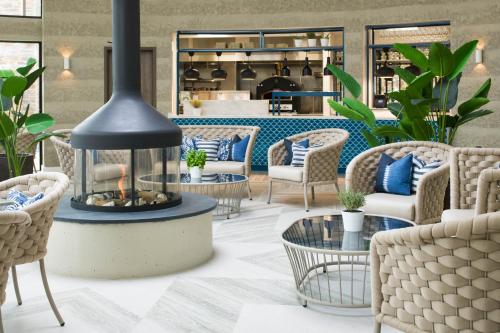 a room with a table, chairs and a fire place at The Headland Hotel and Spa in Newquay