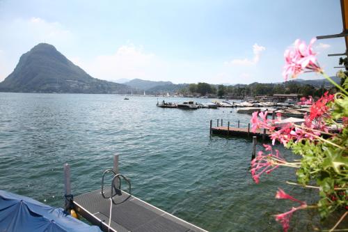 a view of a lake with boats in the water at Hotel Lido Seegarten in Lugano