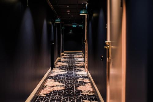a dark corridor with a long aisle with a marble floor at The Vault Hotel, WorldHotels Crafted in Helsingborg