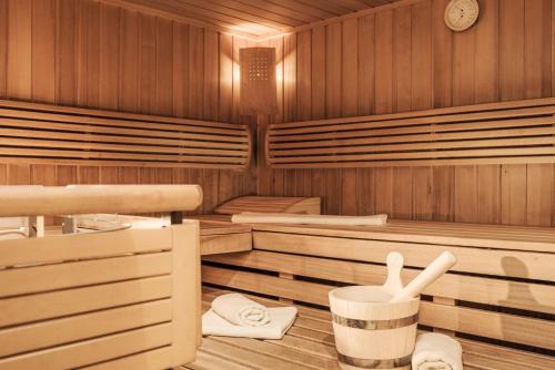 a sauna with wooden floors and a clock on the wall at Hotel Finkenbergerhof in Finkenberg