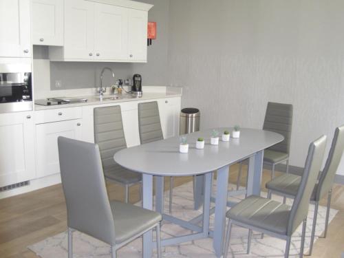 a kitchen with a table and chairs in a kitchen at No.8 Waterloo Street in Birmingham