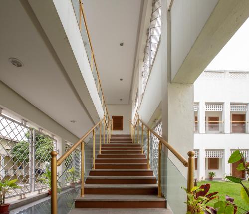 a hallway of a building with stairs and windows at KSTDC Hotel Mayura Hoysala, Mysore in Mysore