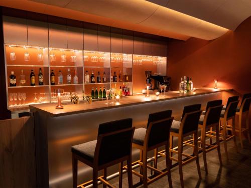 a bar in a restaurant with a bunch of chairs at Hotel Bellclassic Tokyo in Tokyo