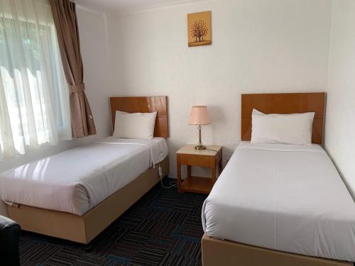 Postel nebo postele na pokoji v ubytování Swaggers Motor Inn