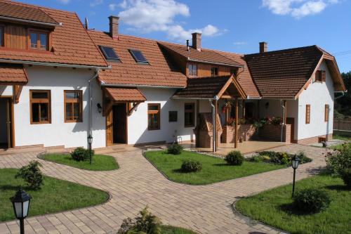 a row of houses with red roofs at Faluszéli Vendégház - Boncz Porta in Nagyrákos