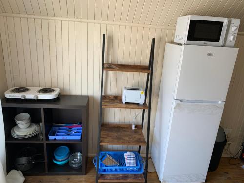 a kitchen with a white refrigerator and a microwave at Hi Loft Living in Newcastle
