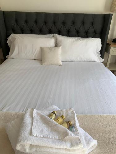 a bed with two towels and two rings on it at Durham Serviced Properties in Durham