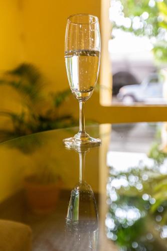 a glass of wine sitting on top of a table at KSTDC Hotel Mayura Hoysala, Mysore in Mysore