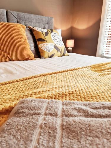 a bed with a blanket and pillows on it at Royal Victoria House in Dundee